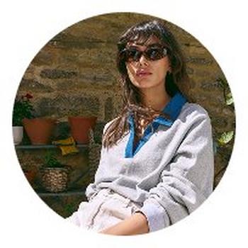a woman in a circle with a potted plant in the background