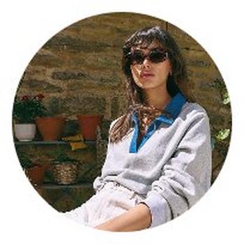 a woman in a circle with a potted plant in the background