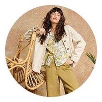 a woman in a dress and jacket posing in a circle