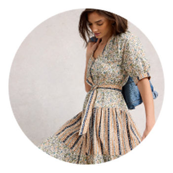 a woman in a dress and jacket posing in a circle