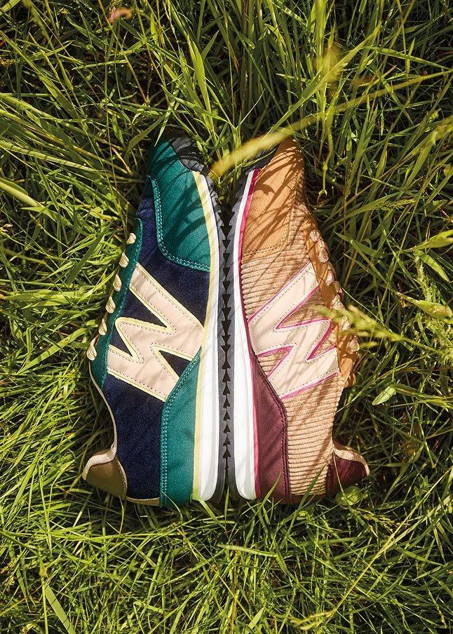 two new balance shoes are laying in the grass