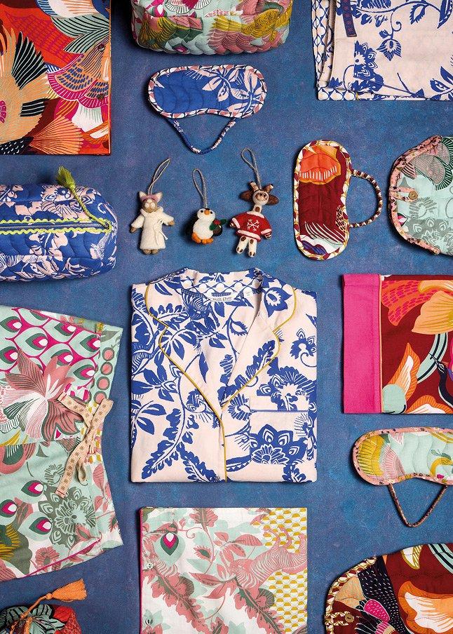 a blue cloth with various items on it including a purse