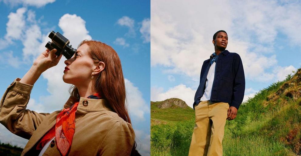 a man and woman looking through binoculars at a hillside