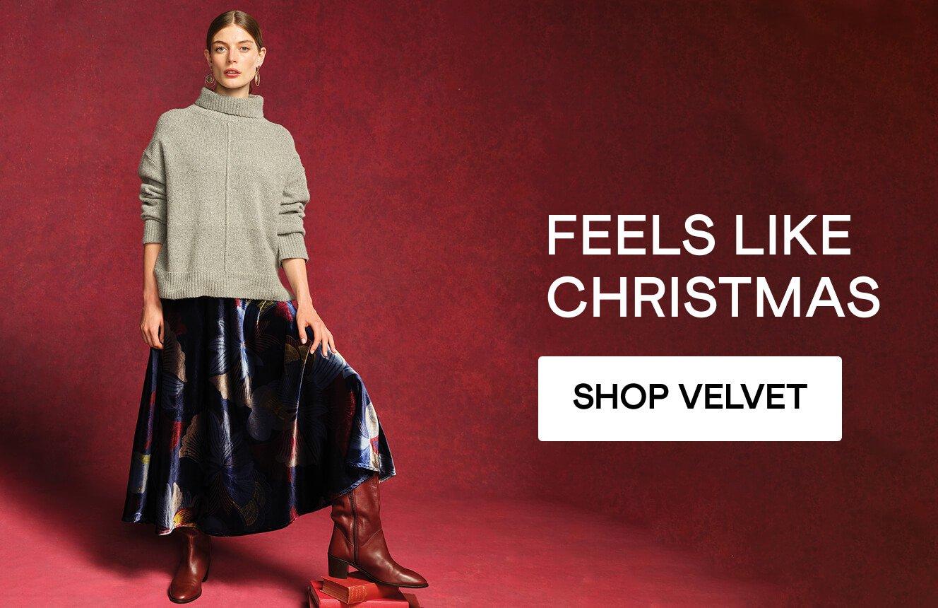 A woman wearing a velvet skirt, click here to shop velvet.