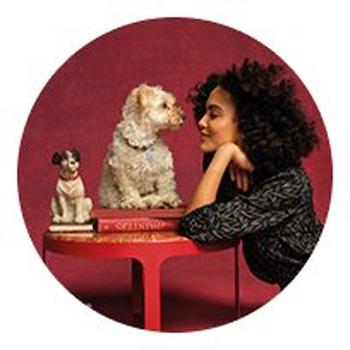 two women standing next to each other in a circle