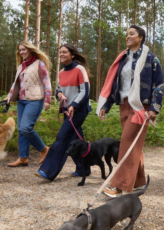 a woman laying on a red table with a dog on top of it