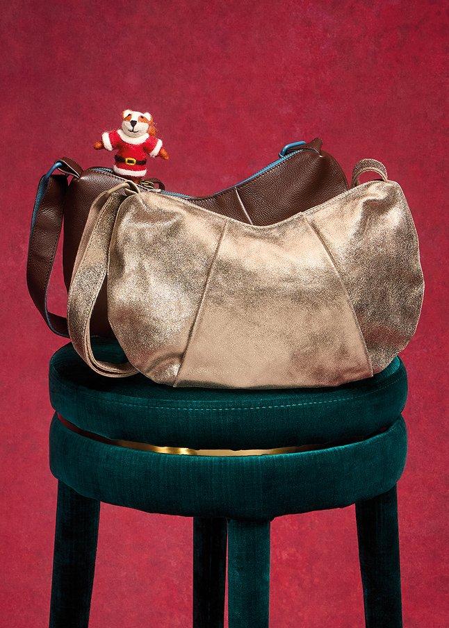 a purse on a stool with a teddy bear sitting on it