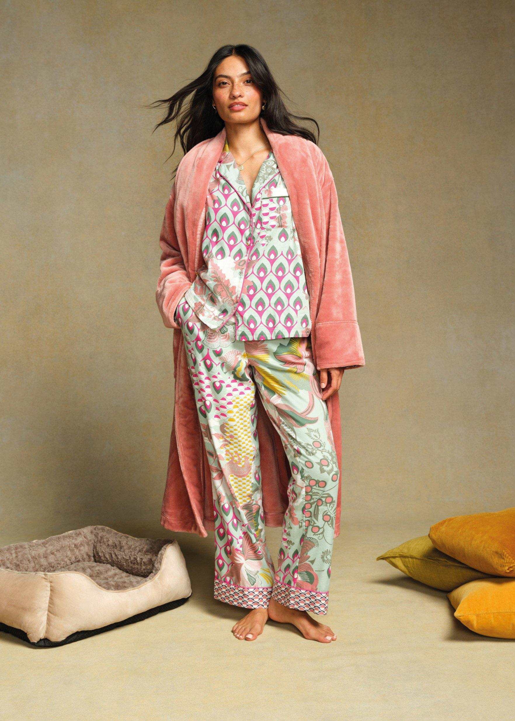 a woman wearing a robe and pyjamas