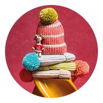 a pile of colorful hats and mittens on a yellow plate