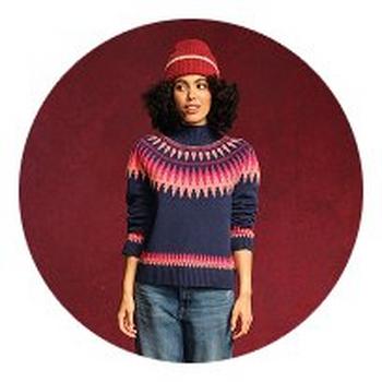 a woman with long white hair and a gold jacket