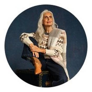 a woman sitting on a suitcase with her legs crossed