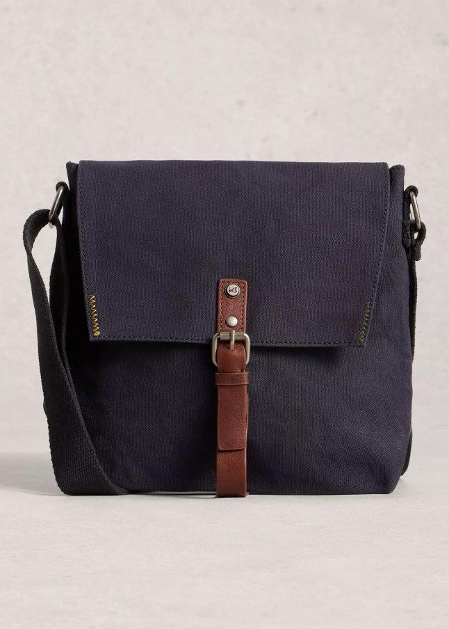 a small blue and brown leather bag with a strap