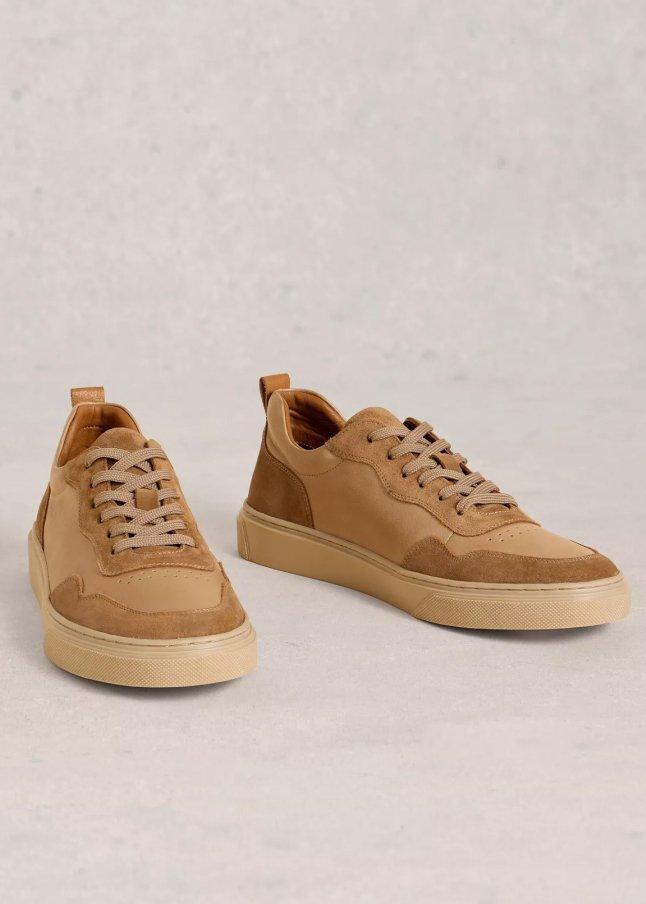 a pair of tan sneakers with laces on them