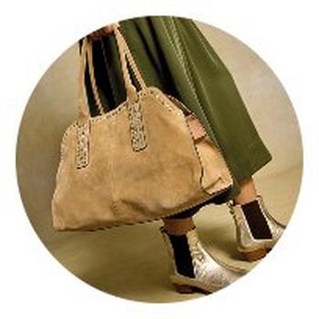 a brown leather bag with a strap on the side