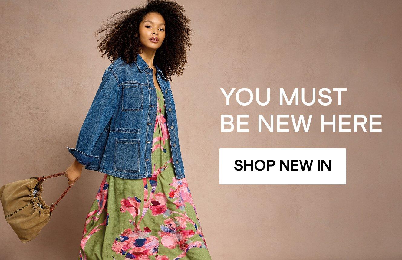 A woman wearing White Stuff clothing. Click here to shop new in