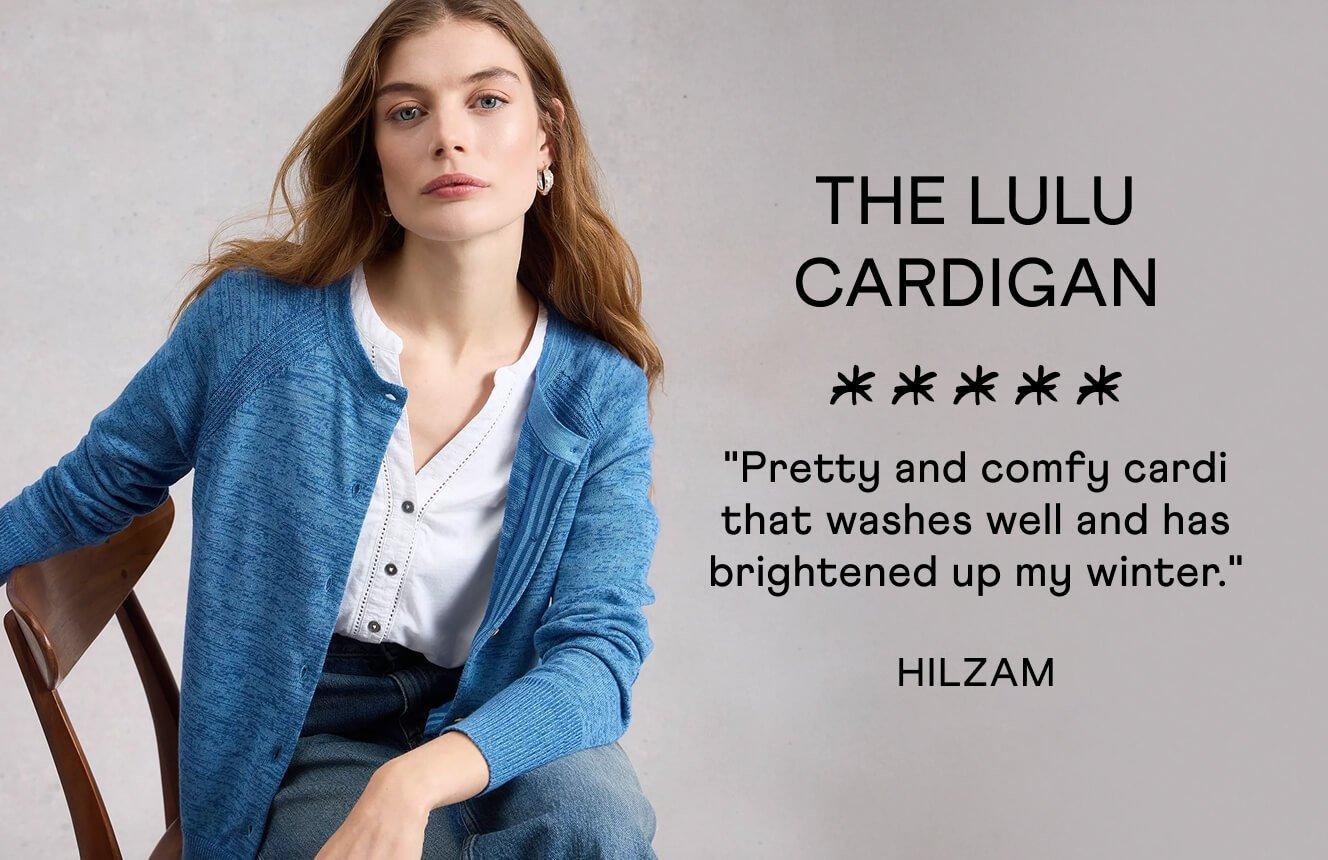 A woman wearing the Lulu Cardigan. Text on Image is a 5 star review written by Hilzam: "Pretty and comfy cardi that washes well and has brightened up my winter".