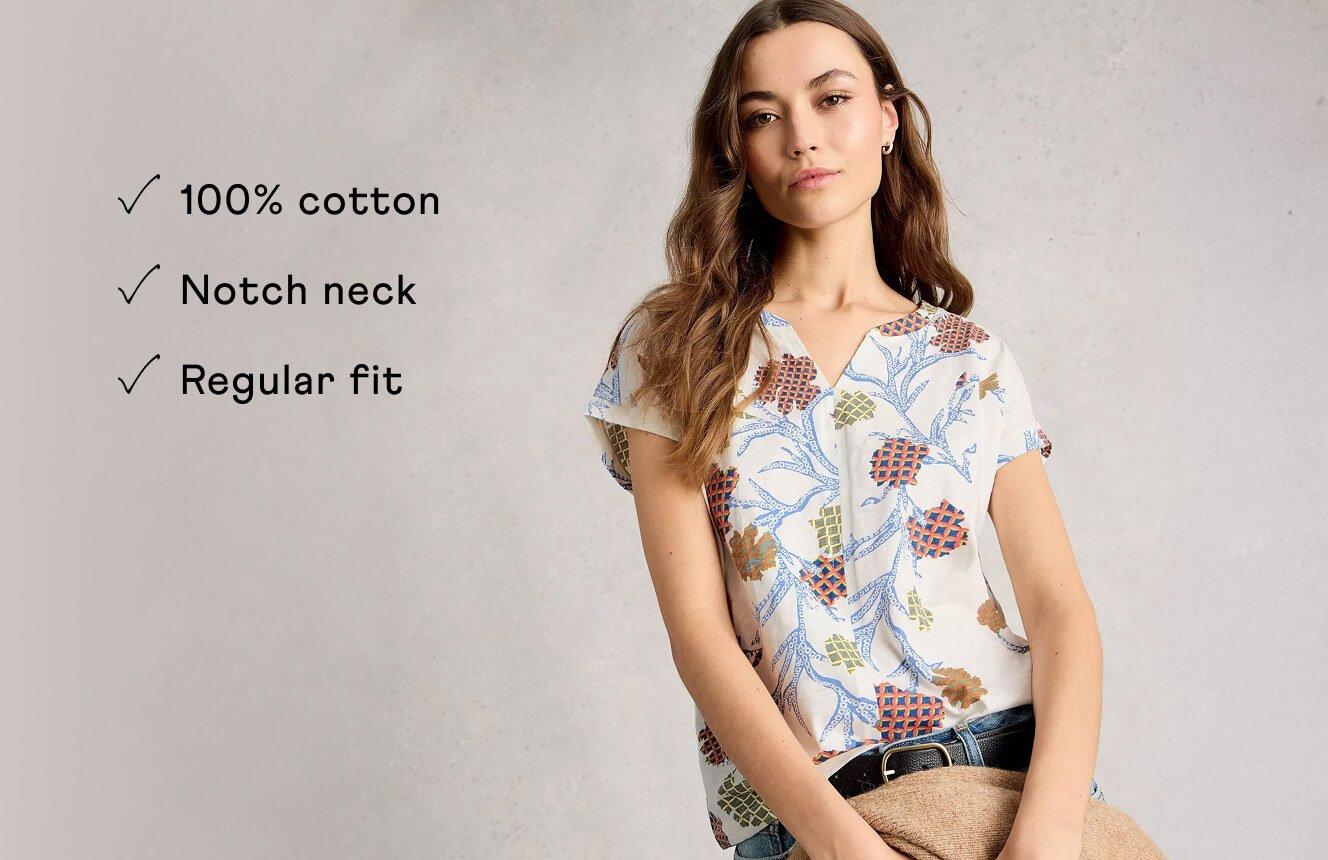 A woman wearing the Nelly Tee. Text on Image is "100% cotton, notch neck, regular fit".