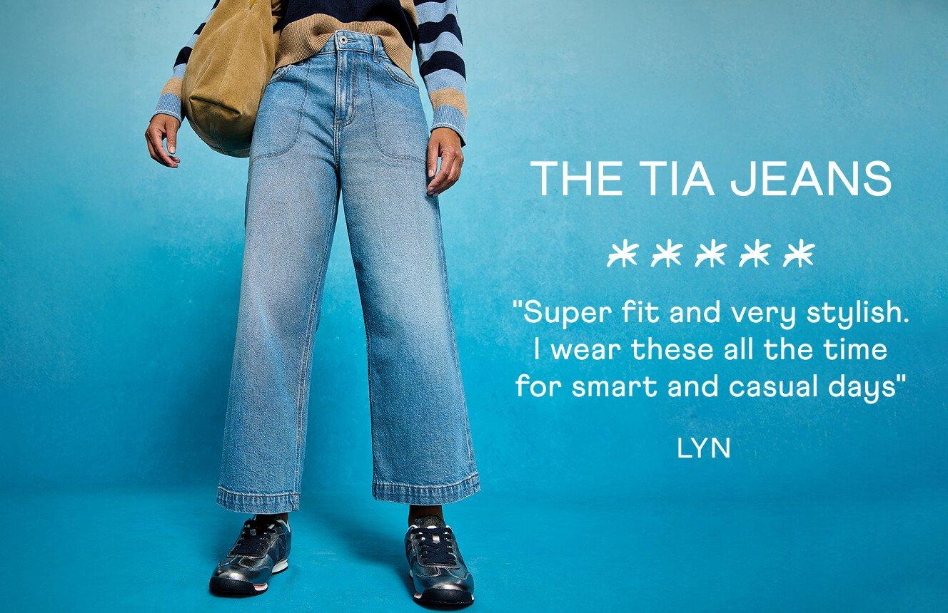 A woman wearing the Tia Jeans. Text on Image is a 5 star review written by Lyn: "Super fit and very stylish. I wear thee all the time for smart and casual days".