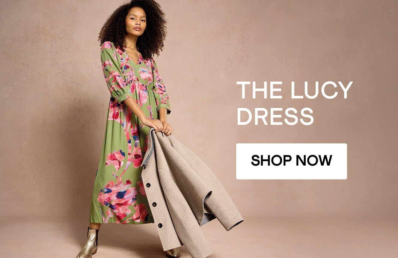 A woman wearing the  Lucy dress. Click here to shop more.