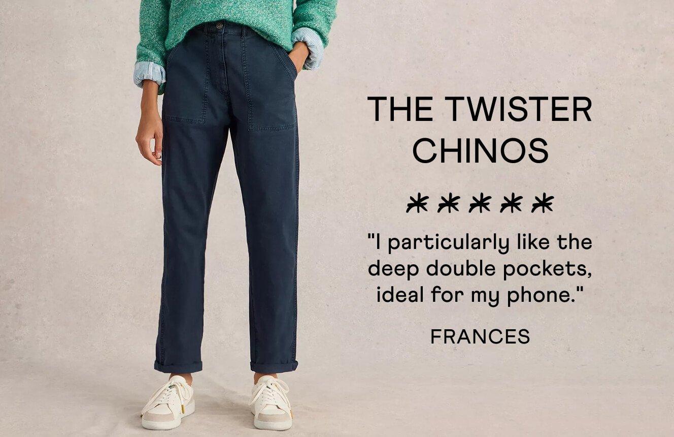 A woman wearing the Twister Chinos. Text on Image is a 5 star review written by Frances: "I particularly like the deep double pockets, ideal for my phone".