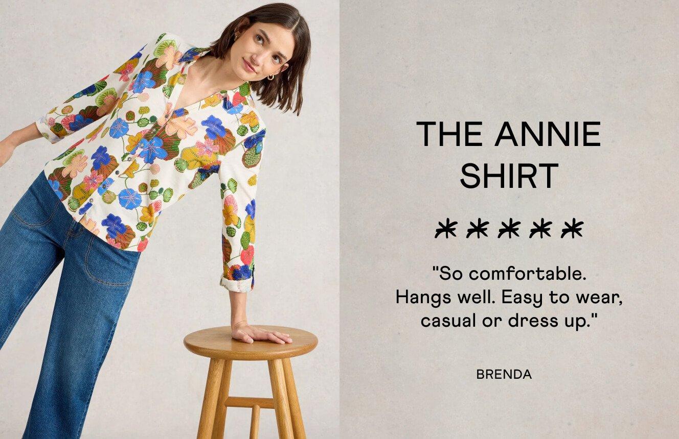 A woman wearing a shirt with a floral print. Next to the woman is a 5 star review for the shirt reading: " So comfortable. Hangs well. Easy to wear, casual or dress up." - reviewed by Brenda