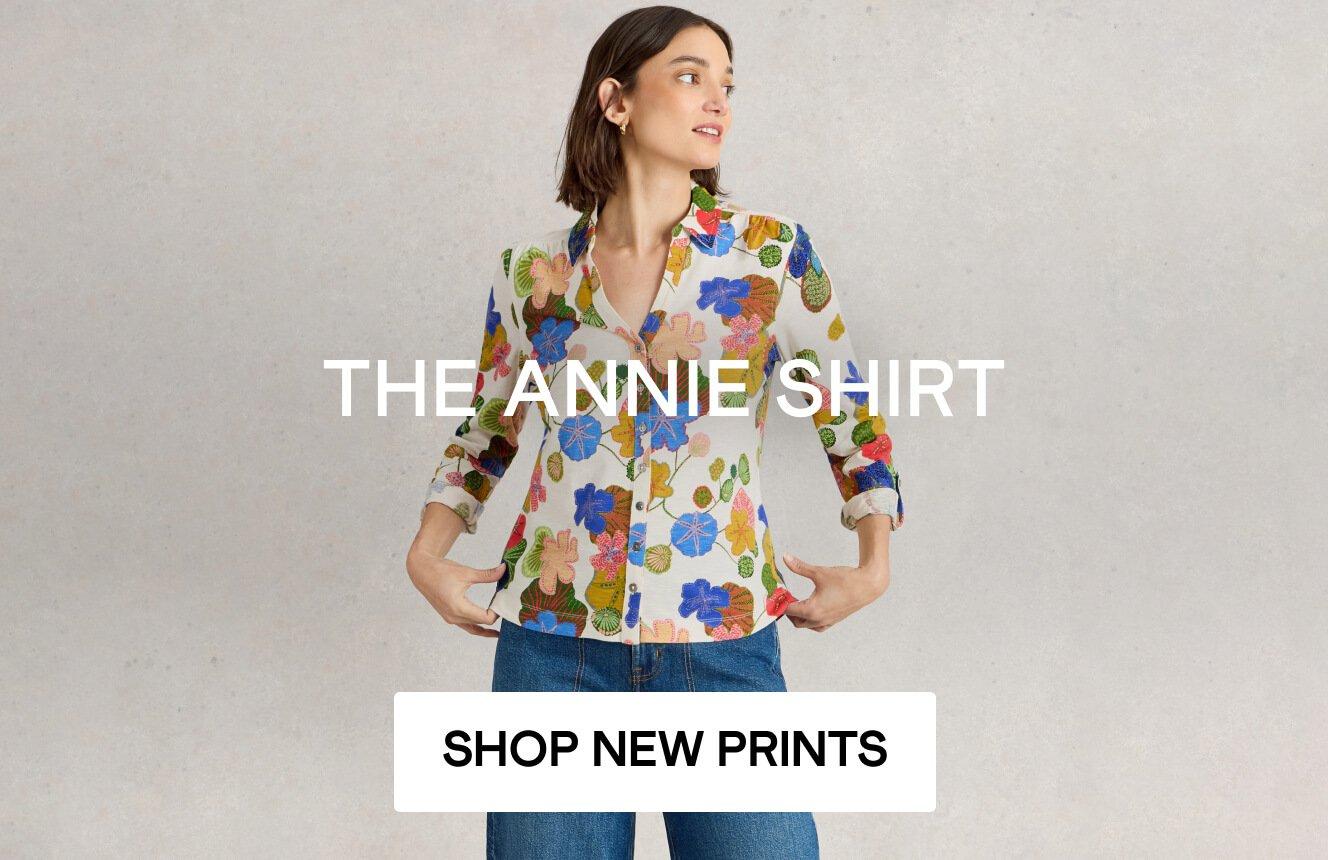 A woman wearing a shirt with a floral print. The words " The Annie Shirt" are shown on the image. Click here to shop all the Annie Shirts.