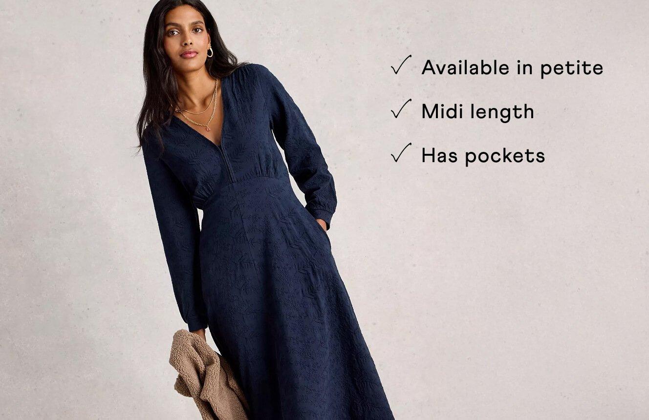 A woman wearing the Megan Dress. Text on Image is "Available in petite, midi length, has pockets".