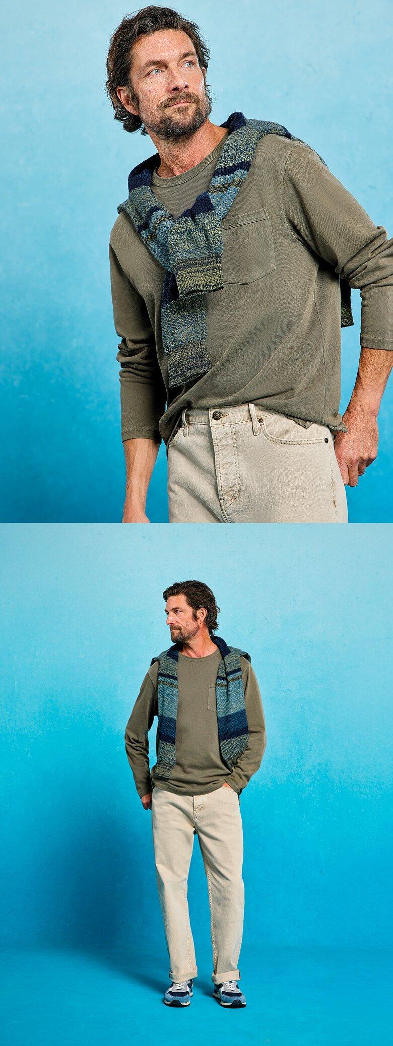 a man in a green shirt and brown pants is posing