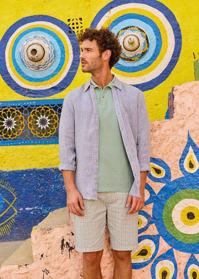 a man standing in front of a colorful wall 