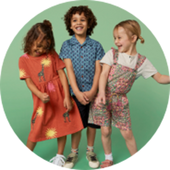 three children standing in a circle with one wearing a dress