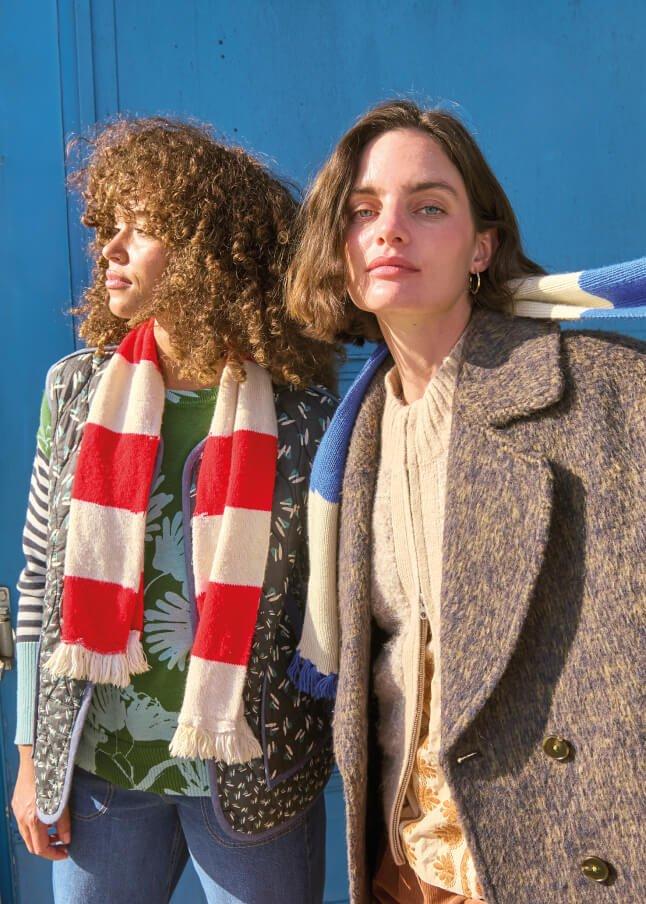 two women standing next to each other with scarves on their heads