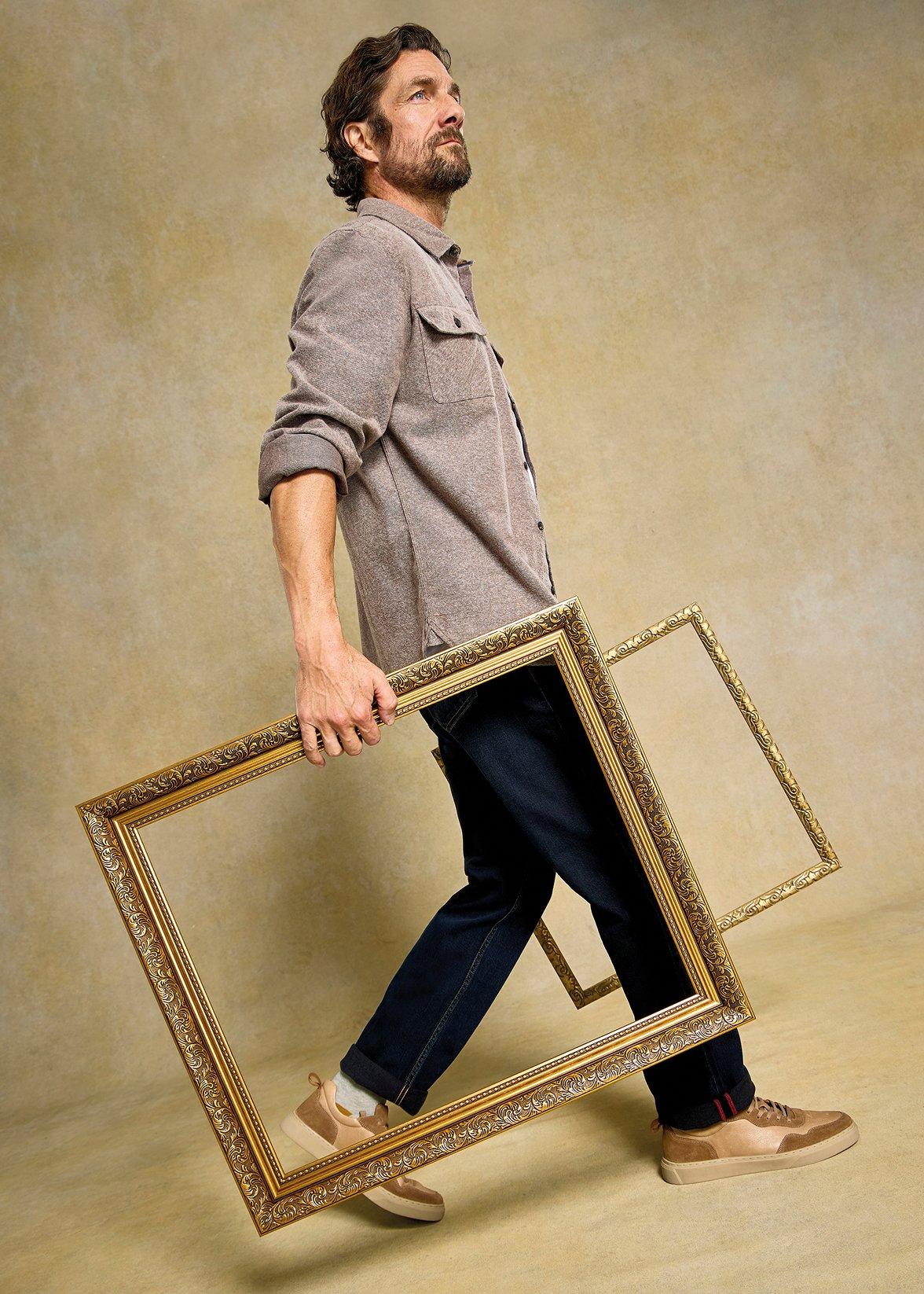 A man wearing the darwen shirt and the eastwood jeans